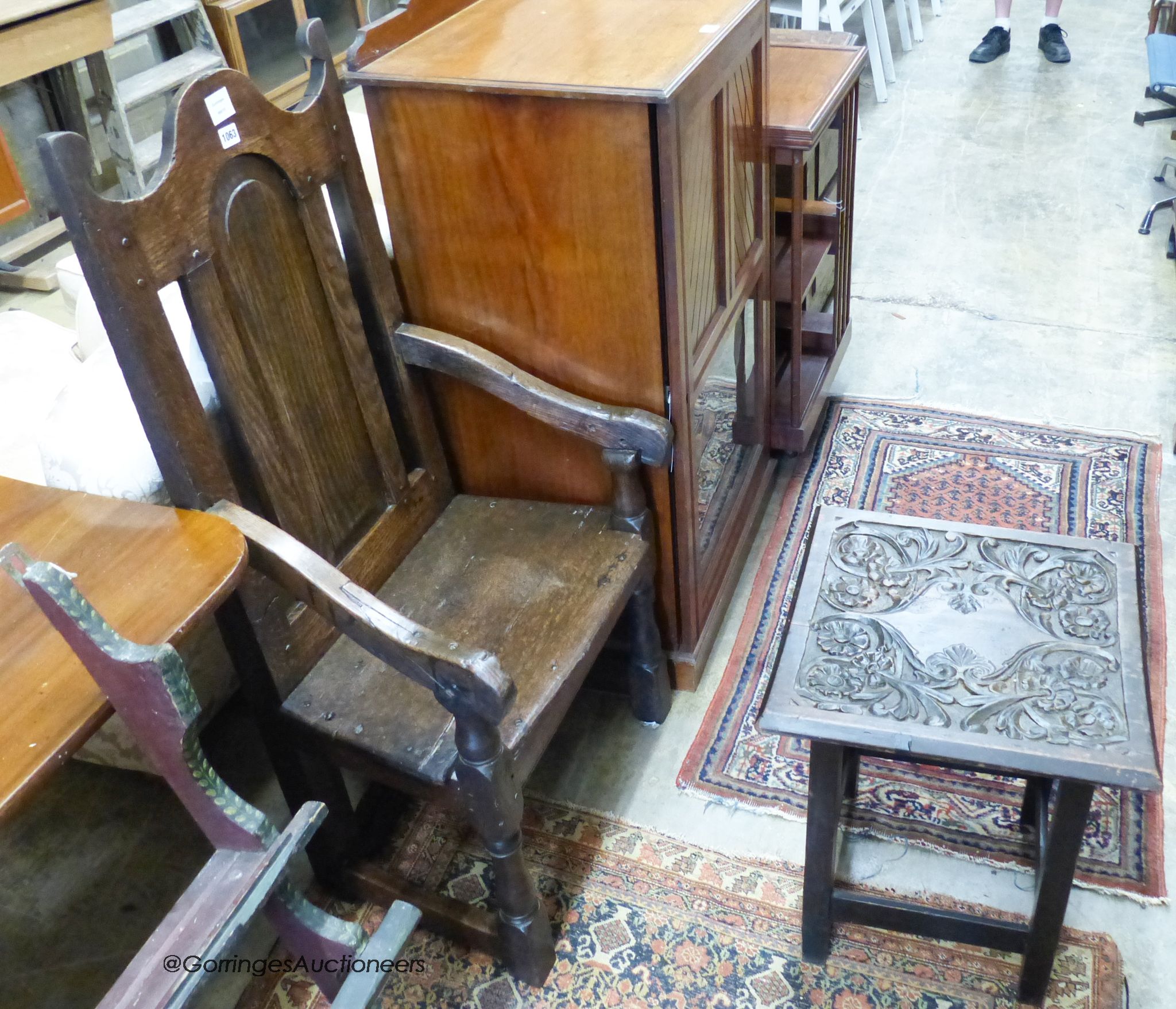 A 17th century style oak armchair and a square occasional table.